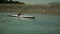 Tracking kayaker rowing on lake while getting closer