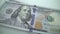 Tracking macro of Benjamine Franklin`s face on the US one hundreed dollar bill. US dollars background