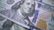 Tracking macro of Benjamine Franklin`s face on the US one hundreed dollar bill. US dollars background