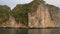 Tracking panning shot from cruise boat sailing through the limestone islands in UNESCO World Heritage site, Ha Long Bay, Vietnam