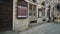 Tracking shot of old architecture style concert hall building, people passing by