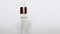 Tracking slider shot of cosmetic pipette in glass bottle on white background