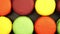 TRACKING: Top view of a Rows of Colorful Macaroons on a black table