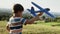 Tracking video of little boy planting seedlings with his grandfather.