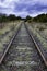Tracks of abandoned railway line with dramatic sky