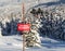 Tracks in the snow beside a ski area boundary sign.