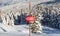 Tracks in the snow beside a ski area boundary sign.