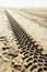 Tracks of tyres of a motorised vehicle on the beach, manmade patterns and structures