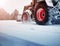 Tracktor cleaning on winter road covered with snow