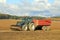 Tractor and Agricultural Trailer on Flax Field