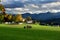 Tractor with a bale wrapper preparing to wrap a hay bale. Village Obermillstatt, Carinthia, Austria