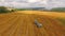 Tractor Baler Collecting Straw In Stubble Field