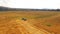 Tractor Baler Driving In Stubble Field