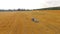 Tractor Baler Making Hay Bales In Stubble Field