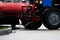 Tractor with a barrel on a trailer pours water over the city sidewalks, streams of water flow down to the ground