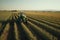 A tractor on a bountiful crop field, highlighting the essential role of agricultural machinery