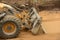 Tractor the bulldozer rows and equals sand