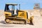 Tractor bulldozer working on road construction