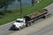 Tractor cab with trailer carrying landfill traveling a  highway