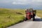 Tractor carries hay on the road in national reserve Durmitor, Montenegro