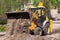 the tractor carries out excavation work in the construction