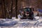 Tractor cleaning snow