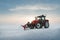 Tractor cleaning snow