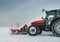 Tractor cleaning snow