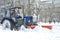 Tractor cleans snow on the street