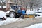 Tractor clears snow in courtyard