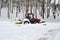 Tractor clears snow in the park