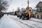 Tractor clears snowy streets