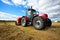 Tractor collecting haystack in the field