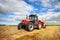 Tractor collecting haystack in the field