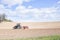 Tractor compresses the soil after planting with rollers.