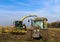 Tractor and corn harvester on the corn field