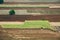 Tractor cultivating field : aerial view