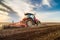 Tractor cultivating field at spring