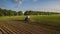 Tractor cultivating field at spring