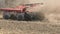 Tractor cultivating land in extreme close up