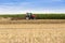 Tractor cultivating wheat stubble field, crop residue