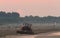 Tractor that at dawn cleans the beach from the rubbish