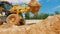 A tractor digs a hole at a construction site. Working process at a construction site. Tractor bucket close up