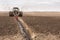 Tractor with double wheeled ditcher digging drainage canal