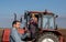 Tractor driver arguing with farm worker on agricultural field