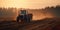 Tractor driving across large field making special beds for sowing seeds into purified soil.