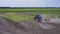 A tractor driving down a dirt road