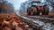 A tractor driving down a muddy road in the fall