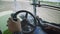 Tractor driving inside view. Tractor cabin. Steering wheel hands