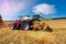 tractor equipped with a stubble cultivator in action in the cereal fields after the harvest